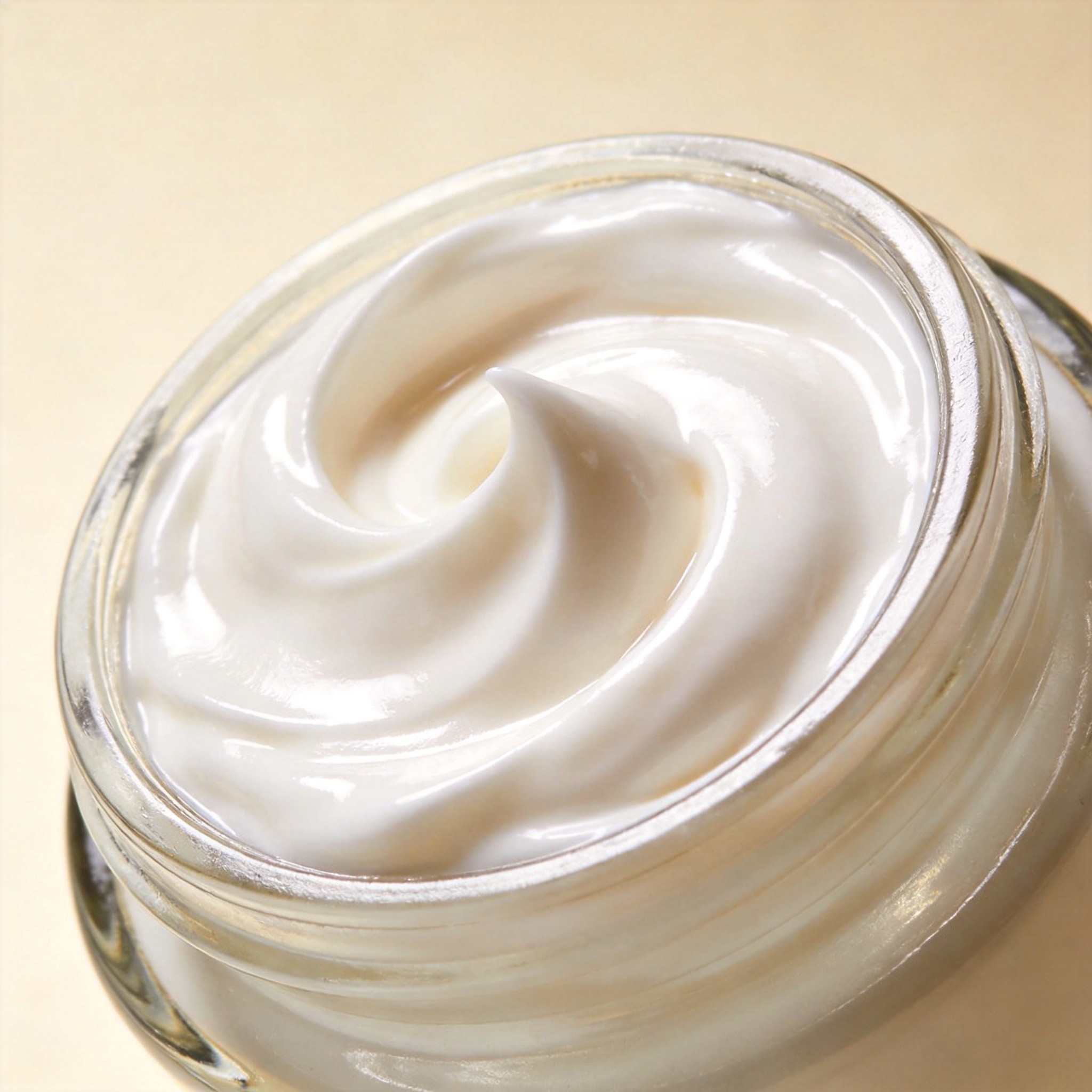 Pearl-white cream swirl in a glass jar